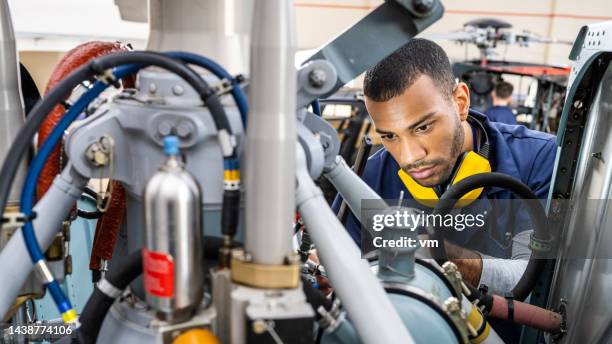 concerned face of aviation maintenance technician examining jet engine, close up - civil aviation stock pictures, royalty-free photos & images