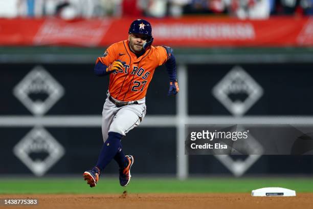 Jose Altuve of the Houston Astros rounds the bases after hitting a triple against the Philadelphia Phillies during the first inning in Game Five of...