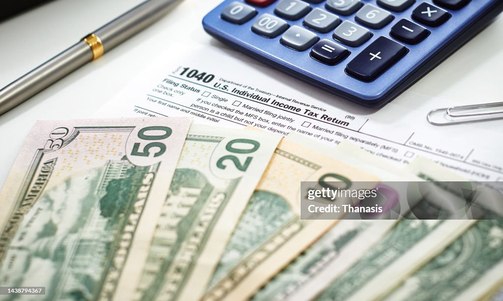 US Currency with calculator and Tax Form
