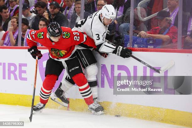 Philipp Kurashev of the Chicago Blackhawks checks Matt Roy of the Los Angeles Kings into the boards during the second period at United Center on...