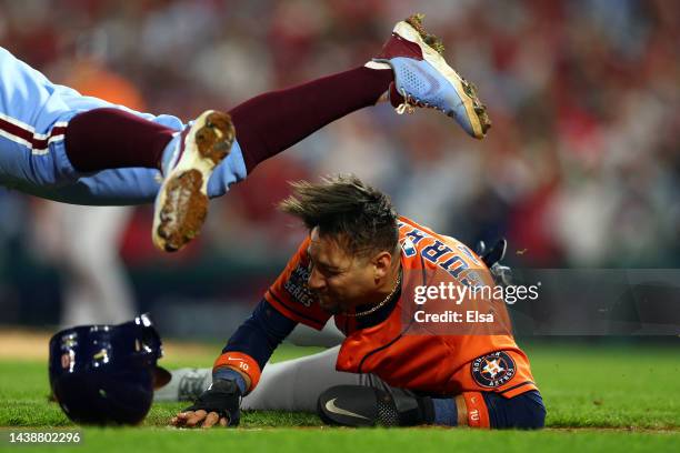 Yuli Gurriel of the Houston Astros is caught in a rundown and is tagged out by Rhys Hoskins of the Philadelphia Phillies during the seventh inning in...