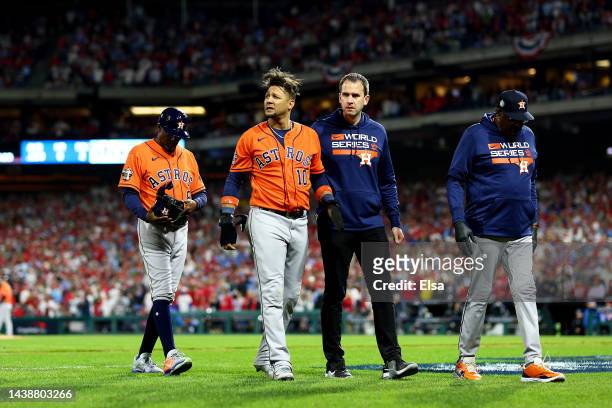 Yuli Gurriel of the Houston Astros is helped off the field after being tagged out in a rundown against the Philadelphia Phillies during the seventh...