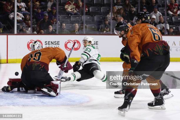 Wyatt Johnston of the Dallas Stars shoots to score a goal past goaltender Connor Ingram of the Arizona Coyotes during the first period of the NHL...