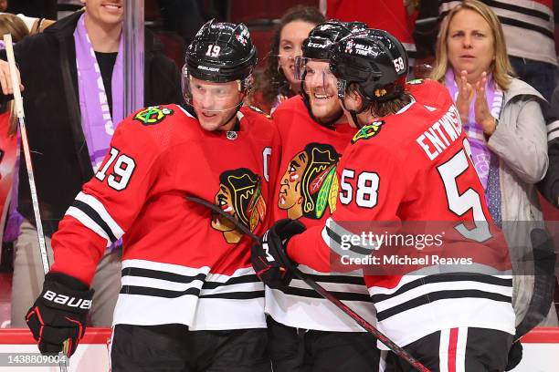 Jonathan Toews of the Chicago Blackhawks celebrates with Jake McCabe and MacKenzie Entwistle after scoring a game-winning goal against the Los...