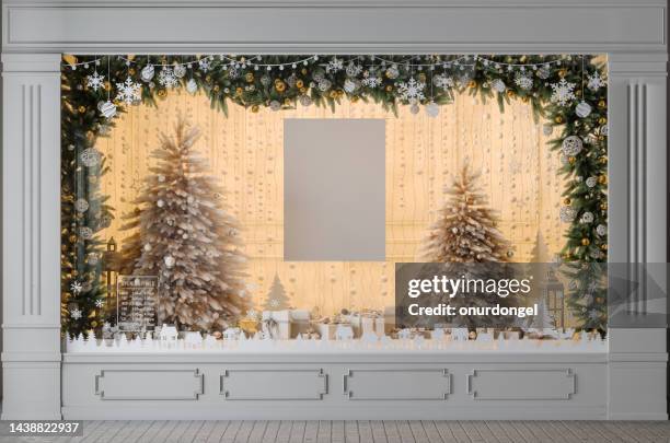 store window display with christmas tree, ornaments, gift boxes and blank poster - butiksfönster bildbanksfoton och bilder