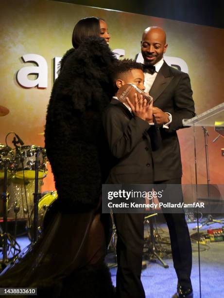 Honoree Kelly Rowland, Tim Weatherspoon, and Titan Jewell Weatherspoon speak onstage during amfAR Gala Los Angeles 2022 at Pacific Design Center on...