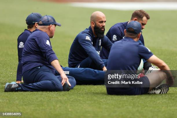 Moeen Ali of England speaks to his team mates as they sit on the ground before the England T20 World Cup team training session at Sydney Cricket...