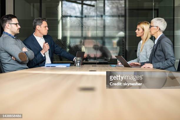 young couple and their lawyers taking about separation in the office. - divorce lawyer stock pictures, royalty-free photos & images