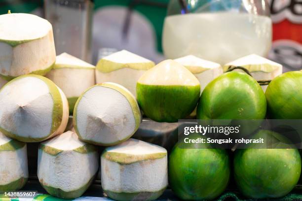 coconuts in the night market - coconut water stock pictures, royalty-free photos & images