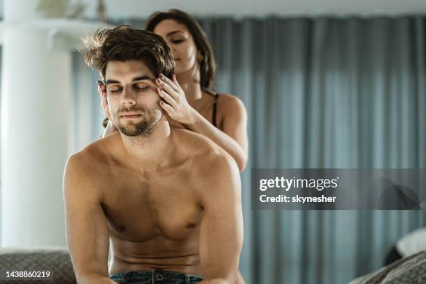 woman massaging her boyfriend's head in the bedroom. - massage couple 個照片及圖片檔