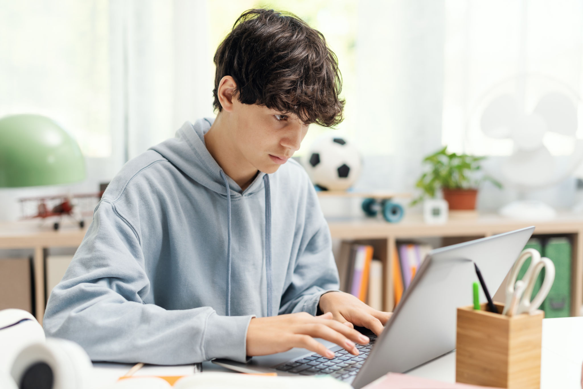 student typing laptop