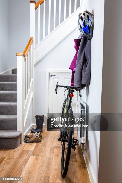 property interior scene with in modern residential house hallway with bicycle and  winter jackets hanging on hooks - draped scarf stock pictures, royalty-free photos & images