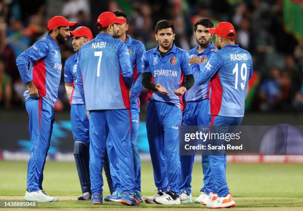 Fazalhaq Farooqi of Afghanistan with team mates after bowling Matthew Wade of Australia for 6 runs during the ICC Men's T20 World Cup match between...