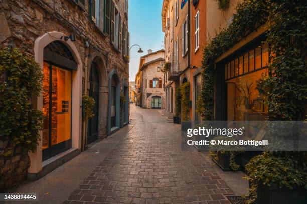 narrow alley in the old town of como, italy. - como italia stock pictures, royalty-free photos & images