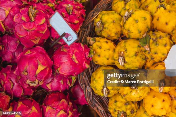 basket of passion fruits in local market, madeira, portugal - pitaya stock pictures, royalty-free photos & images