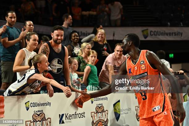 Majok Deng of the Taipans greets fans with team mates after the round six NBL match between Cairns Taipans and Melbourne United at Cairns Convention...