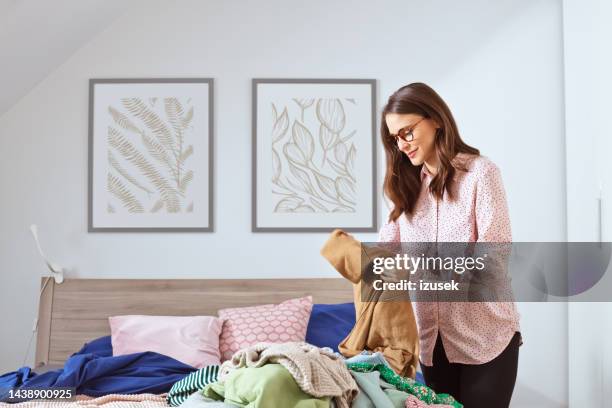 woman selling her clothes online - decluttering stock pictures, royalty-free photos & images