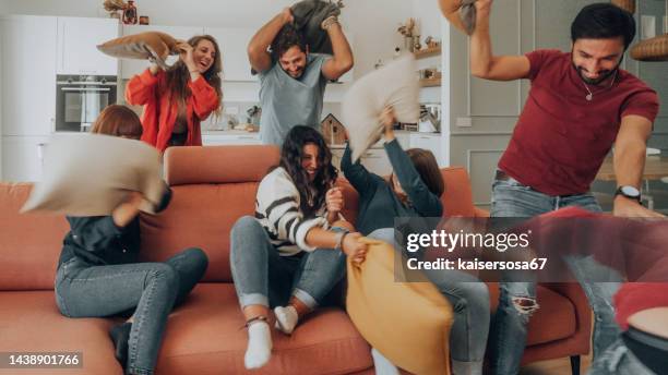 happy friends having a funny pillow fight - battle comic bildbanksfoton och bilder