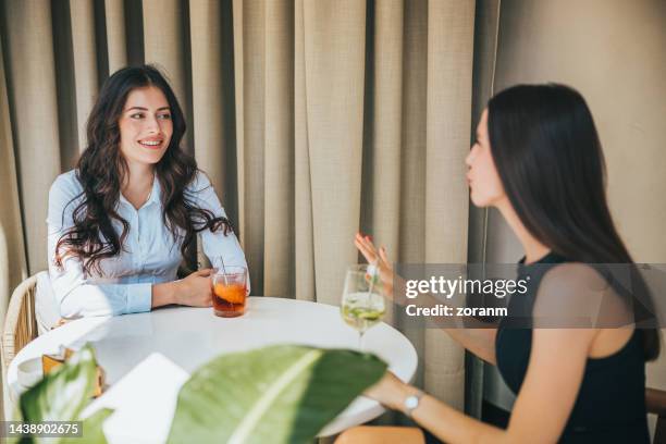 beautiful women sitting in restaurant in business investment meeting, negotiating new investment - bar drink establishment stock pictures, royalty-free photos & images