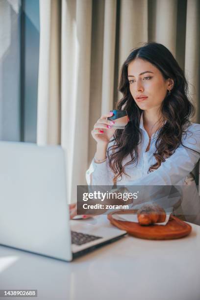 beautiful woman sitting in café and discussing investments in video conference on laptop, - bar drink establishment stock pictures, royalty-free photos & images
