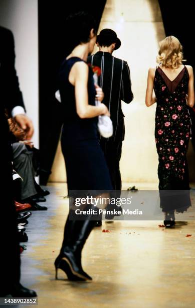 Designer Cynthia Rowley accepts a bouquet of flowers on the runway at show finale.