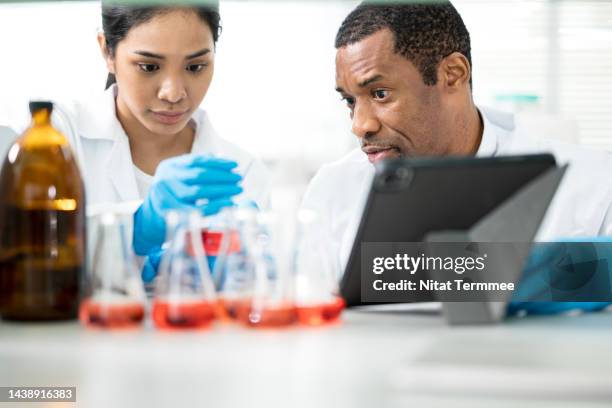 laboratory testing petroleum and chemicals. a diversity of chemists has discussed their research on chemical solution samples in a laboratory. - chromatography stock pictures, royalty-free photos & images