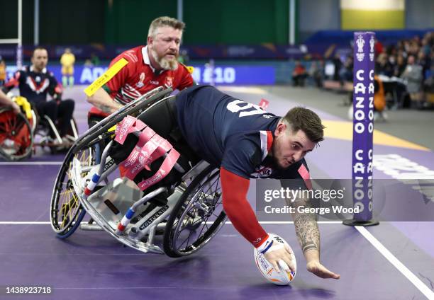 Arno Vargas of France touches down to score their team a try while under pressure from Martin Lane of Wales during the Wheelchair Rugby League World...