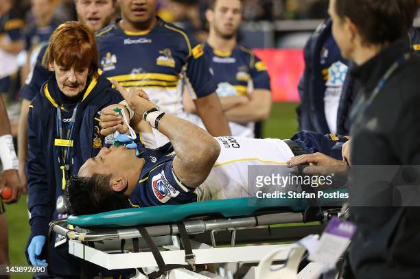 Christian Lealiifano holds up a finger while being taken off injured after the round 11 Super Rugby match between the Brumbies and the Waratahs at...