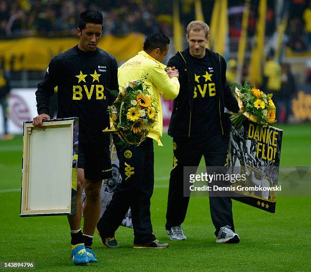 Lucas Barrios of Dortmund and teammates Antonio da Silva and Florian Kringe walk on the pitch prior to the Bundesliga match between Borussia Dortmund...