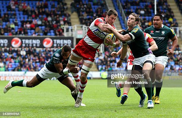 Matt Cox of Gloucester is tackled by Sailosi Tagicakibau and Steven Shingler of London Irish during the Aviva Premiership match between London Irish...