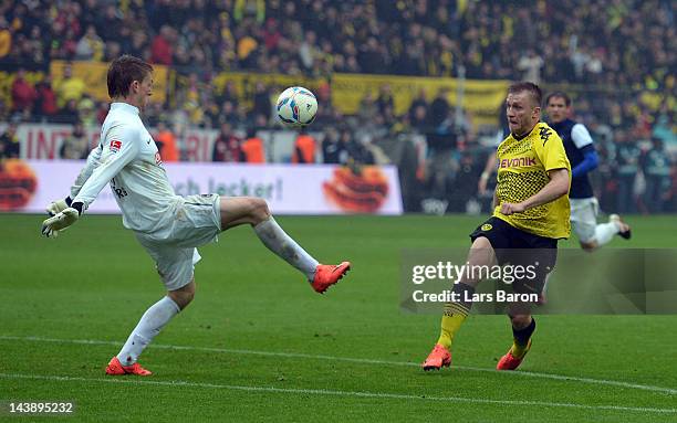 Jakub Blaszczykowski of Dortmund scores his teams fourth goal past goalkeeper Daniel Batz of Freiburg during the Bundesliga match between Borussia...
