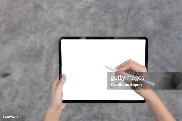 close-up hand woman using digital tablet isolated on white background clipping path inside, mock-up digital black tablet - pen mockup stock pictures, royalty-free photos & images