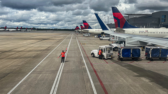 Ground crews send off a Delta Airline flight at the busiest airport in the US.