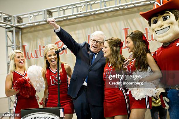 Warren Buffett, chairman of Berkshire Hathaway Inc., sings a song with University of Nebraska cheerleaders during an event at the Berkshire Hathaway...