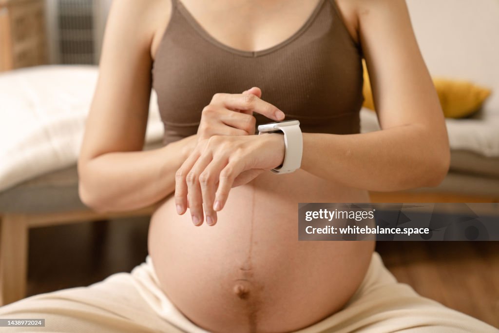 Pregnant woman practicing yoga and doing meditation.