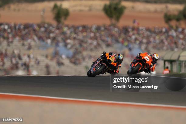 Brad Binder of South Africa and Red Bull KTM Factory Racing leads Raul Fernandez of Spain and Tech3 KTM Factory Racing during the MotoGP of Comunitat...