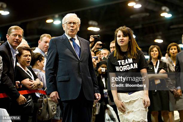 Warren Buffett, chairman of Berkshire Hathaway Inc., reacts to the toss of a young participant during a newspaper toss event at the Berkshire...