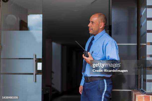 security guards are inside the building that they take care of making sure that everything is in order - security man stock pictures, royalty-free photos & images