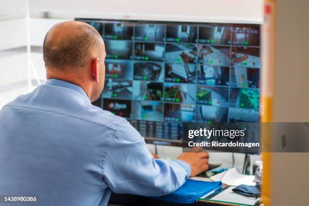 security guards are inside the building that they take care of making sure that everything is in order - business security camera stock pictures, royalty-free photos & images