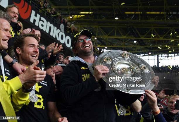 Juergen Klopp, head coach of Dortmund lifts the trophy after winning the german championship after the Bundesliga match between Borussia Dortmund and...