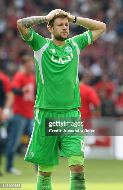 Marco Russ of Wolfsburg reacts after his team's loss of the Bundesliga match between VfB Stuttgart and VfL Wolfsburg at Mercedes-Benz Arena on May 5,...