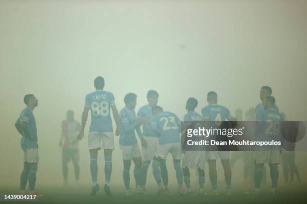 The players of Lazio speak in the smoke from flares and fireworks prior to the UEFA Europa League group F match between Feyenoord and SS Lazio at...