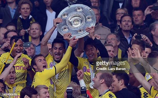 Shinji Kagawa of Dortmund lifts the trophy after winning the Bundesliga match between Borussia Dortmund and SC Freiburg at Signal Iduna Park on May...