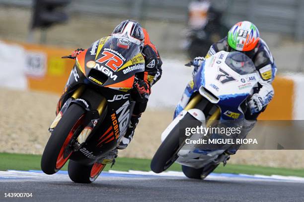 Mobile Forward Racing team's Yuki Takahashi rides ahead of Italtrans Racing team's Italian rider Claudio Corti during the Moto 2 qualifying practice...