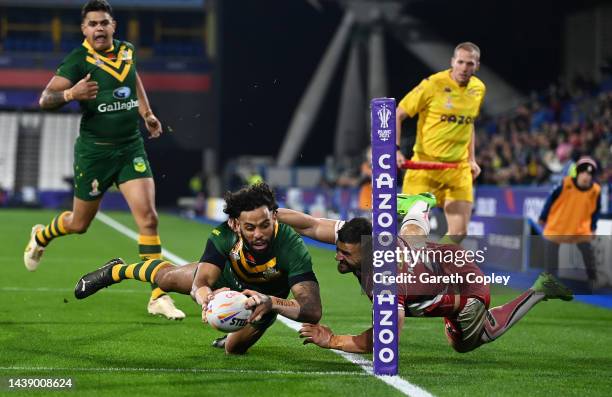 Josh Addo-Carr of Australia touches down for their team's first try while under Josh Mansour of Lebanon during the Rugby League World Cup Quarter...