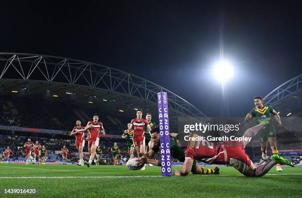 Josh Addo-Carr of Australia touches down for their team's first try while under Josh Mansour of Lebanon during the Rugby League World Cup Quarter...