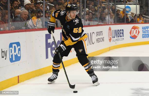 Jake Guentzel of the Pittsburgh Penguins skates with the puck in the first period during the game against the Boston Bruins at PPG PAINTS Arena on...