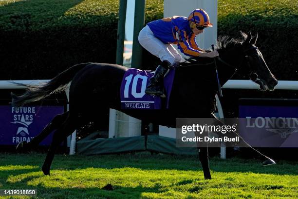 Jockey Ryan Moore rides Meditate to win the Breeders' Cup Juvenile Fillies Turf Sprint during the 2022 Breeders Cup at Keeneland Race Course on...