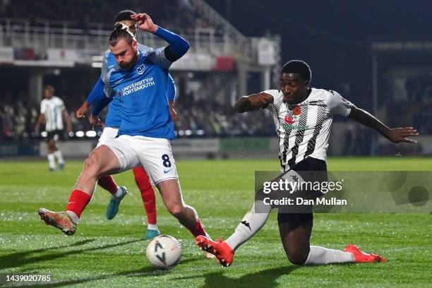 Jethro Hanson of Hereford battles for the ball with Ryan Tunnicliffe of Portsmouth during the FA Cup First Round match between Hereford FC and...