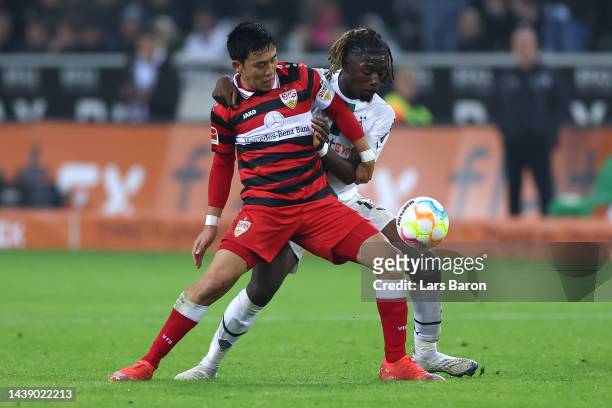 Kouadio Emmanuel Kone of Borussia Monchengladbach battles for the ball with Wataru Endo of VfB Stuttgart during the Bundesliga match between Borussia...